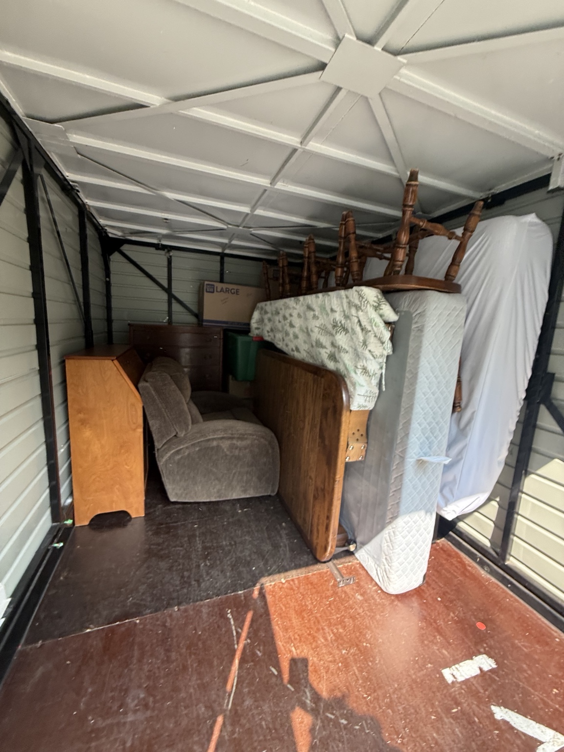 Furniture, mattresses and household items inside a storage container